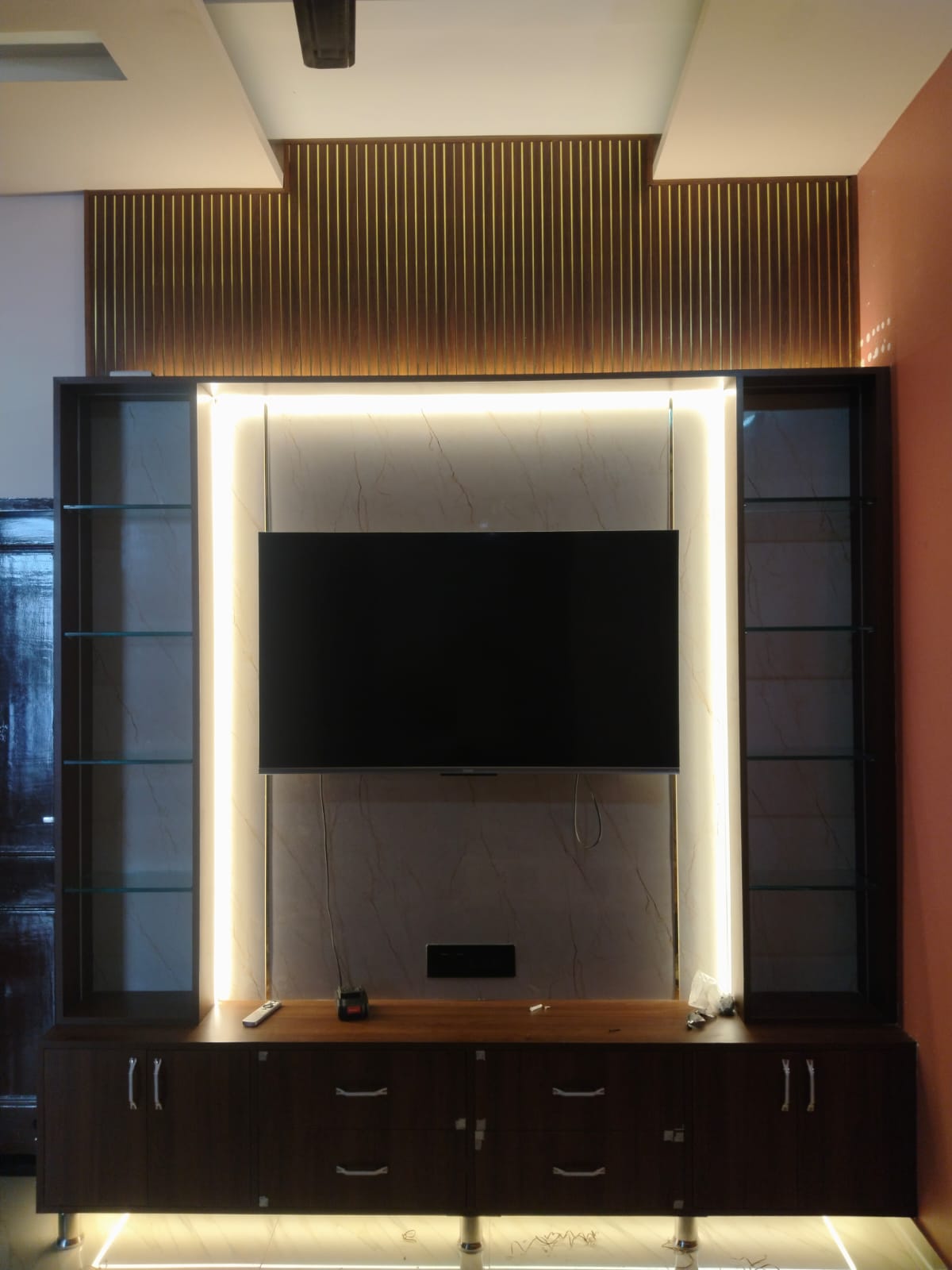 Close view of the lit glass display towers flanking the screen