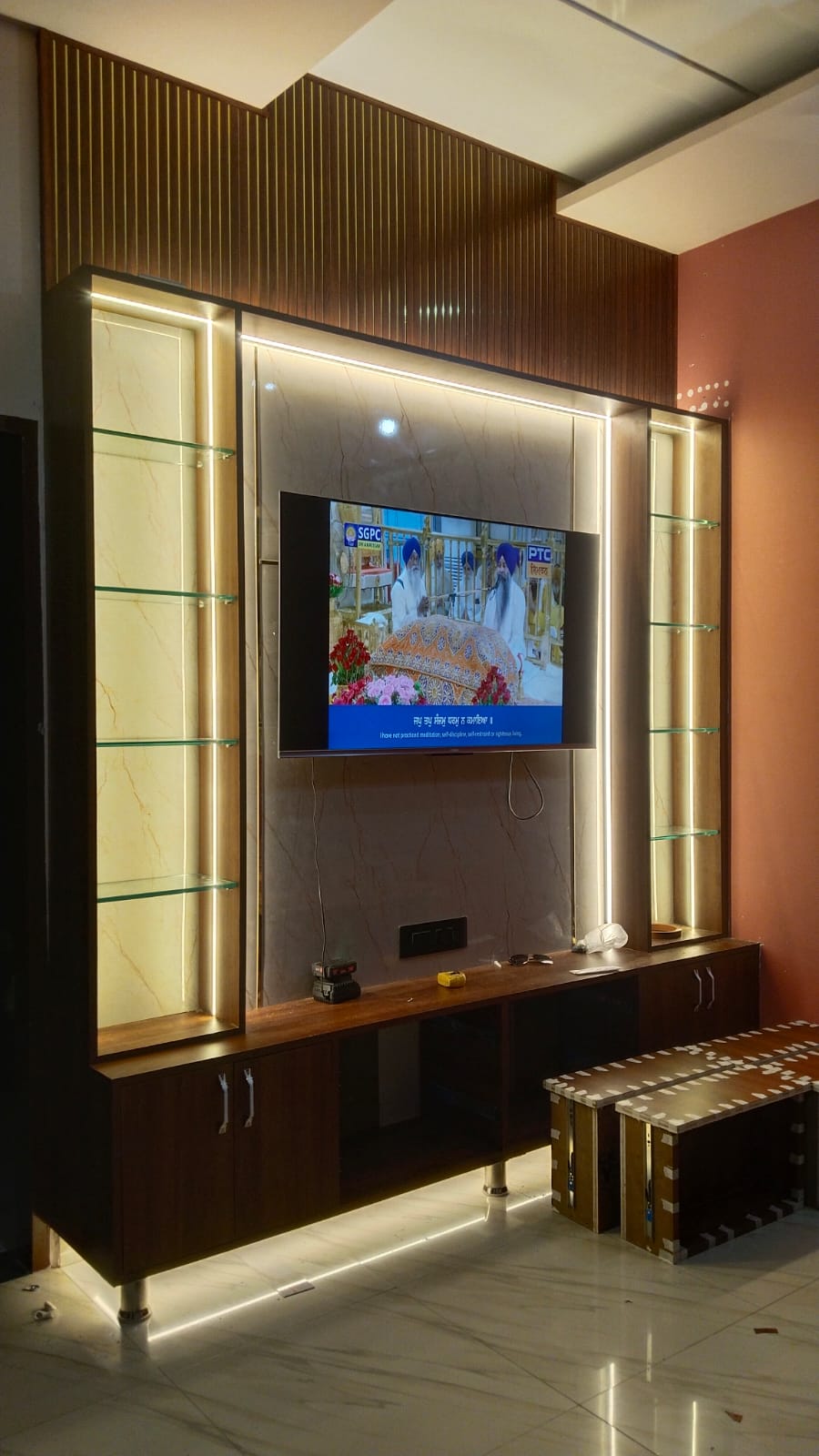 The finished wall in use with the television playing and the lighting on
